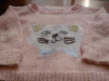 Hand-knit sweater with kitten face on front